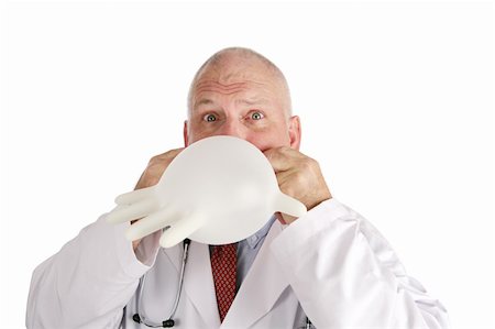 rubber hand gloves - A silly doctor blowing up his rubber glove.  Isolated on white. Stock Photo - Budget Royalty-Free & Subscription, Code: 400-04486317