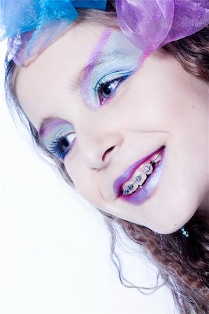 preteen in lipstick - Studio portrait of a young girl with heavy make-up Foto de stock - Super Valor sin royalties y Suscripción, Código: 400-04486496