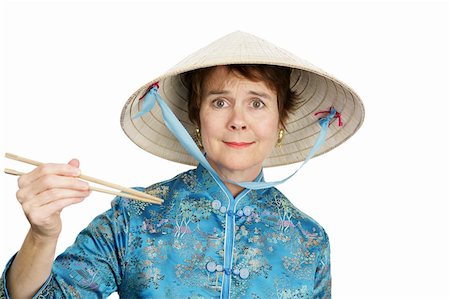 A tourist in Chinatown confused by chopsticks.  Isolated on white. Photographie de stock - Aubaine LD & Abonnement, Code: 400-04486616