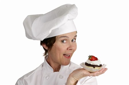 A friendly female chef holding a strawberry cheesecake tart.  Isolated on white. Foto de stock - Super Valor sin royalties y Suscripción, Código: 400-04486612