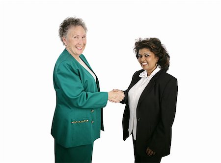 A diverse female business team shaking hands and smiling at the camera.  Isolated on white. Stock Photo - Budget Royalty-Free & Subscription, Code: 400-04486626