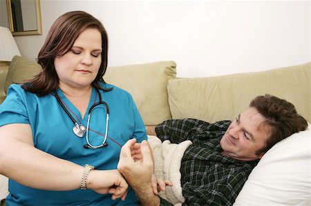 fat men in uniform - A home health nurse taking the patient's pulse. Stock Photo - Budget Royalty-Free & Subscription, Code: 400-04486646