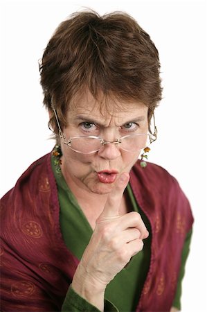 simsearch:640-02656814,k - An angry middle aged librarian putting her finger to her lips to tell you to be quiet.  Isolated on white Photographie de stock - Aubaine LD & Abonnement, Code: 400-04486648