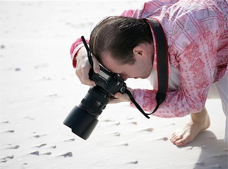 simsearch:400-04880707,k - A photographer shooting a macro of shells on the beach. Stock Photo - Budget Royalty-Free & Subscription, Code: 400-04486688