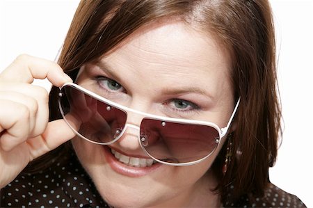 peeping fashion - Closeup of a beautiful model wearing stylish sunglasses.  White background. Stock Photo - Budget Royalty-Free & Subscription, Code: 400-04486696
