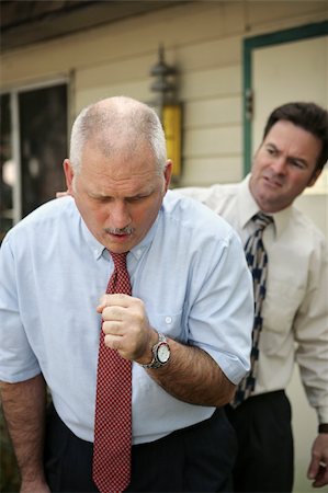 simsearch:400-03972278,k - A businessman doubled over in a coughing fit as a coworker looks on. Stock Photo - Budget Royalty-Free & Subscription, Code: 400-04486734
