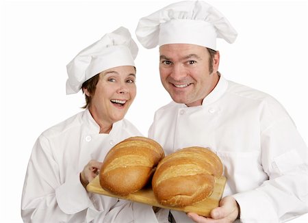 A male and female chef holding loaves of fresh baked Italian bread.  Isolated on white. Stock Photo - Budget Royalty-Free & Subscription, Code: 400-04486732