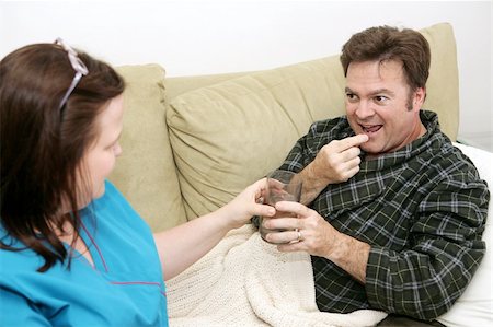 fat men in uniform - Patient taking medication from his home health care nurse. Stock Photo - Budget Royalty-Free & Subscription, Code: 400-04486823