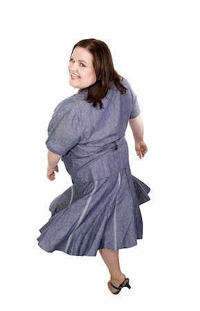 dress for fat women - Beautiful plus sized model twirling around with her dress flaring.  Full body isolated on white. Stock Photo - Budget Royalty-Free & Subscription, Code: 400-04486840