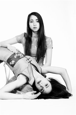 simsearch:400-03974280,k - Studio portrait of two beautiful mixed race vietnamese sisters in black and white Foto de stock - Super Valor sin royalties y Suscripción, Código: 400-04487564