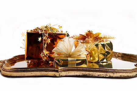 simsearch:400-06101480,k - Christmas gifts wrapped in gold paper on the bronze old-fashioned mirror with white background Stock Photo - Budget Royalty-Free & Subscription, Code: 400-04487595