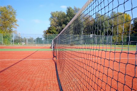 empty tennis court - tennis court under blue sky, with the net as leading line (wide angle) Stock Photo - Budget Royalty-Free & Subscription, Code: 400-04487812