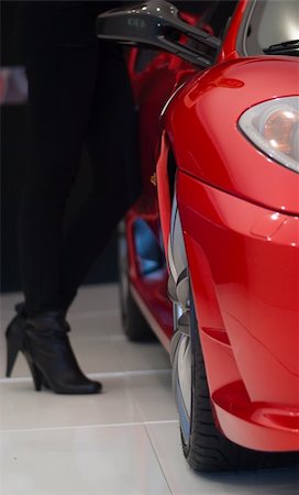 Redl luxury car and woman's leg in this composition where the focus is on the car Stock Photo - Budget Royalty-Free & Subscription, Code: 400-04487918