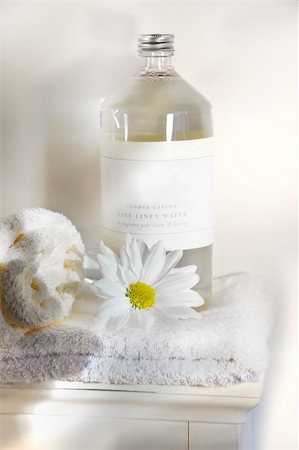 dry body towel - Bottle of linen water with towels and flower on cabinet Stock Photo - Budget Royalty-Free & Subscription, Code: 400-04488306