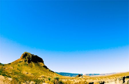 parched - A rock formation reaching into a beautiful, bright, blue expanse of sky. Stock Photo - Budget Royalty-Free & Subscription, Code: 400-04480080