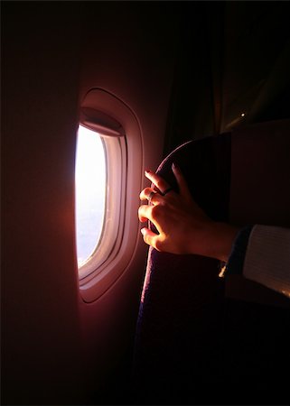 sunset small plane - Window of the plane and female hand Stock Photo - Budget Royalty-Free & Subscription, Code: 400-04480097