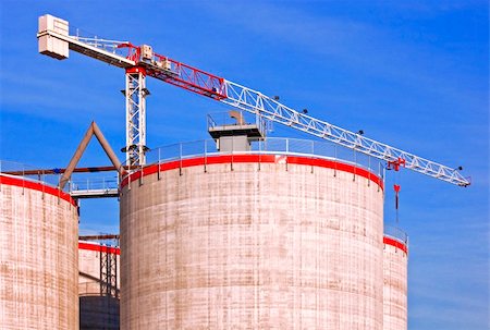 Silos under construction with crane against a blue sky Stock Photo - Budget Royalty-Free & Subscription, Code: 400-04480540
