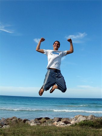 simsearch:400-04450996,k - Young boy jumping on air against blue sky Stock Photo - Budget Royalty-Free & Subscription, Code: 400-04480853