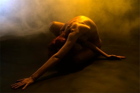 peaceful human - Portrait of a naked model with bright red hair doing a yoga pose in yellow smoke Foto de stock - Super Valor sin royalties y Suscripción, Código: 400-04481908