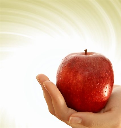 simsearch:400-04564926,k - Red apple in a girl hand. Photographie de stock - Aubaine LD & Abonnement, Code: 400-04482516