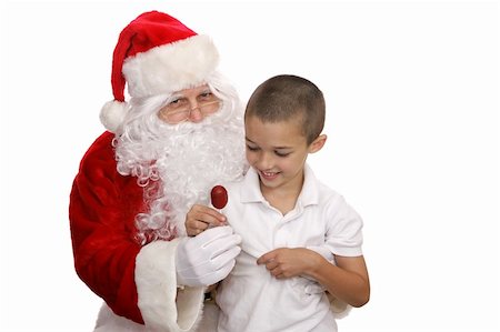 simsearch:400-05008640,k - Adorable little boy sitting on Santa's lap and getting a lolipop.  Isolated on white. Photographie de stock - Aubaine LD & Abonnement, Code: 400-04482798