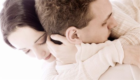 simsearch:400-03965426,k - Studio portrait of a young couple cuddling Stock Photo - Budget Royalty-Free & Subscription, Code: 400-04482792