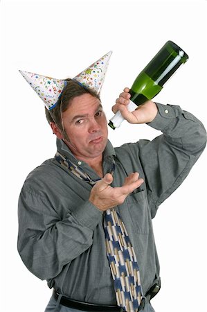 A man in a party hat holding an empty champagne bottle and looking sad. Stock Photo - Budget Royalty-Free & Subscription, Code: 400-04482872