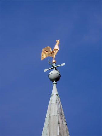 weather vane as a gold cock on the high cone roof of old building Stock Photo - Budget Royalty-Free & Subscription, Code: 400-04483058