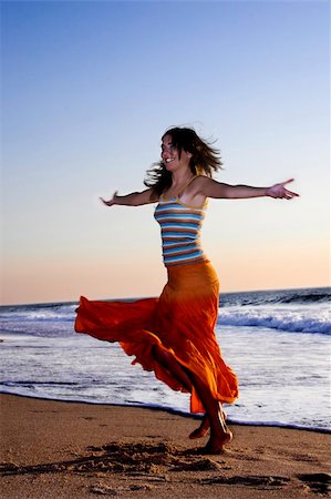 Beautiful woman dancing in the beach Stock Photo - Budget Royalty-Free & Subscription, Code: 400-04483430