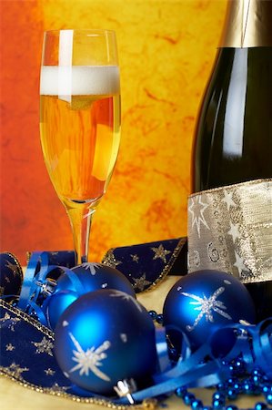 simsearch:400-05082002,k - Christmas decoration with champagne bottle and full glass over colour background. Shallow DOF Photographie de stock - Aubaine LD & Abonnement, Code: 400-04483820