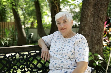 A sweet senior lady relaxing on a park bench.   Room for text. Stock Photo - Budget Royalty-Free & Subscription, Code: 400-04483951