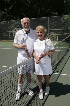 An attractive senior couple on the tennis courts.  Full view vertical. Stock Photo - Budget Royalty-Free & Subscription, Code: 400-04483980