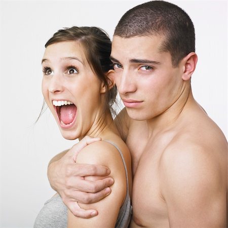 A young man with his arm around a young woman. Stock Photo - Budget Royalty-Free & Subscription, Code: 400-04495210