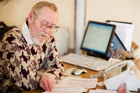 Senior at work place in office with computer notes and fax Stock Photo - Budget Royalty-Free & Subscription, Code: 400-04495700