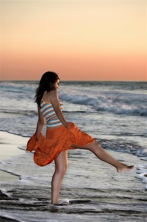 Woman in the beach spreading water Stock Photo - Budget Royalty-Free & Subscription, Code: 400-04496304