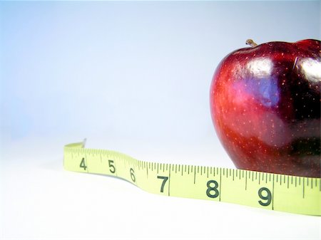 simsearch:400-08532856,k - Apple on white with measuring tape signifying weight watching or weight loss Stock Photo - Budget Royalty-Free & Subscription, Code: 400-04496349