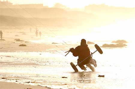 A man kite buggying at the beach at sunset Stock Photo - Budget Royalty-Free & Subscription, Code: 400-04496768