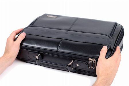 Male hands holding black briefcase over white background Photographie de stock - Aubaine LD & Abonnement, Code: 400-04496798