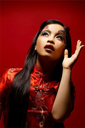 simsearch:400-04780842,k - Beautiful Asian girl as a plastic doll on red background Stock Photo - Budget Royalty-Free & Subscription, Code: 400-04497035