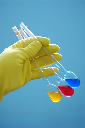 simsearch:400-07091851,k - yellow glove holding chemical liquids in flasks Stock Photo - Budget Royalty-Free & Subscription, Code: 400-04497515