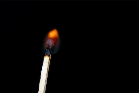 simsearch:640-03262777,k - Close of a matchstick lit against a dark background Photographie de stock - Aubaine LD & Abonnement, Code: 400-04498231