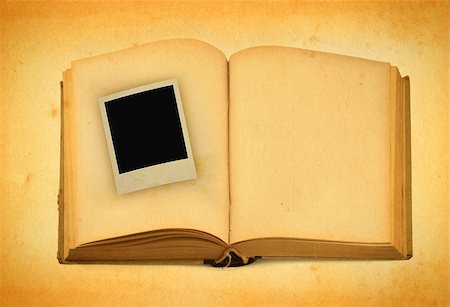 decaying antique books - old book with empty photo frame inside Stock Photo - Budget Royalty-Free & Subscription, Code: 400-04498452