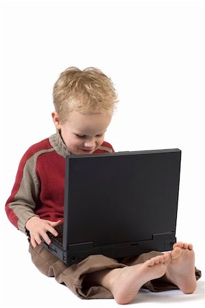 Five year old boy working on a laptop computer. Fotografie stock - Microstock e Abbonamento, Codice: 400-04498745