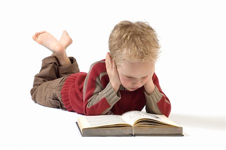 5 year old reading a book, isolated on white. Book is an old children's Bible. Fotografie stock - Microstock e Abbonamento, Codice: 400-04498743