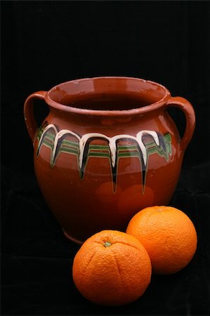 old ceramic pot and oranges on black background Stock Photo - Budget Royalty-Free & Subscription, Code: 400-04498808