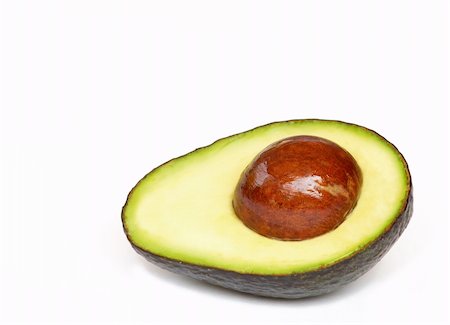 half of an avocado with pit remaining Stock Photo - Budget Royalty-Free & Subscription, Code: 400-04499074