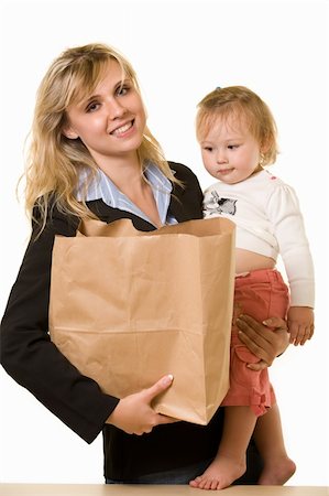 Attractive blond woman in business attire carrying a grocery bag in one arm and baby in the other showing busy mother Photographie de stock - Aubaine LD & Abonnement, Code: 400-04499082