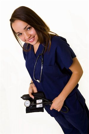 simsearch:400-03995908,k - Pretty young woman healthcare worker wearing blue scrubs and a stethoscope holding blood pressure cuff smiling Stock Photo - Budget Royalty-Free & Subscription, Code: 400-04499115