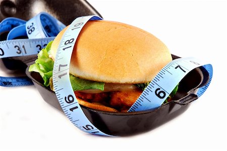 provolone - Fried chicken sandwich with lettuce, tomato, and provolone on a bun on a plate surrounded by a measuring tape. Stock Photo - Budget Royalty-Free & Subscription, Code: 400-04499156
