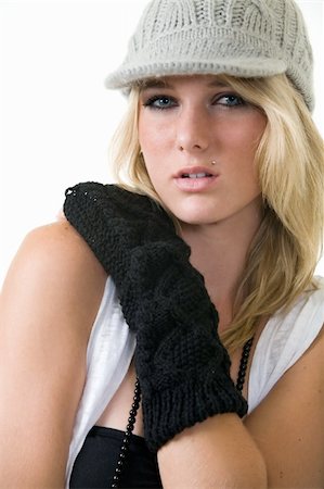 simsearch:400-04502103,k - Face of a cute blond hair young woman wearing funky wool hat and black arm coverings for a funky style on white Stock Photo - Budget Royalty-Free & Subscription, Code: 400-04499394
